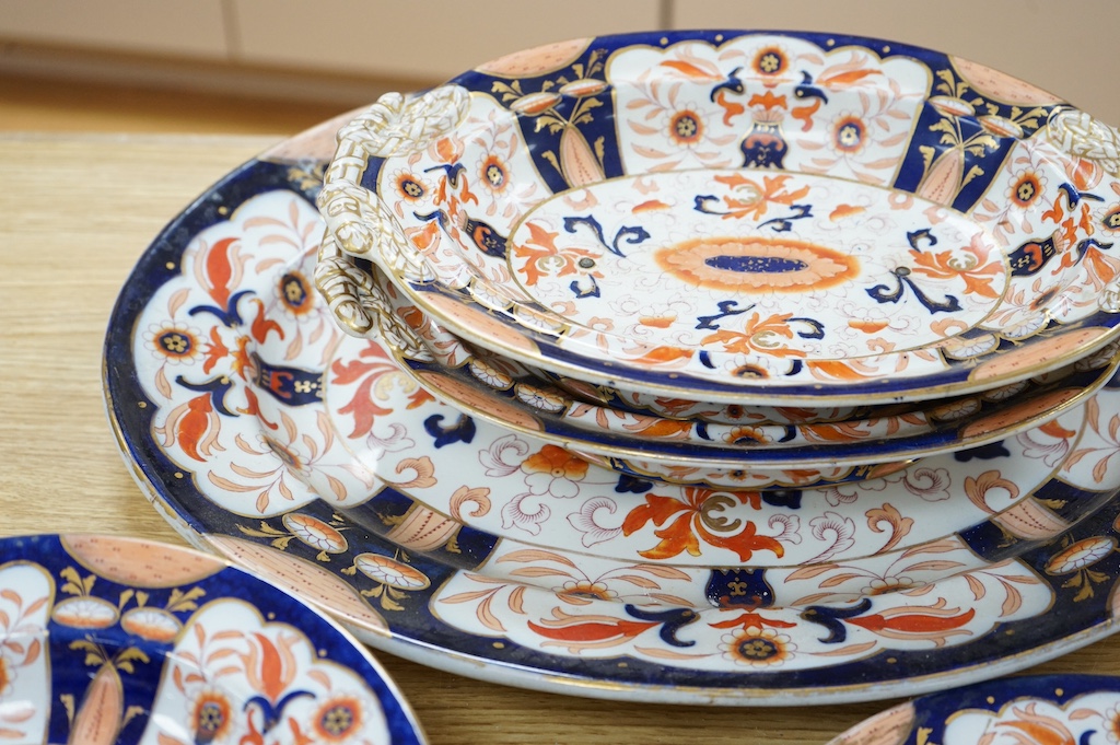 Fifteen items of a mid 19th century Mason's/Ashworth’s ironstone dinner service. Oval meat platter 48.5cm wide. Condition - three plates chipped, some losses to gilding